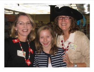 Carolyn Henger Oaks (left) currently manages the author visit grant requests from schools. She’s pictured with her daughter, Maggie, and author June Sobel during a pirate-themed Family Night event. 